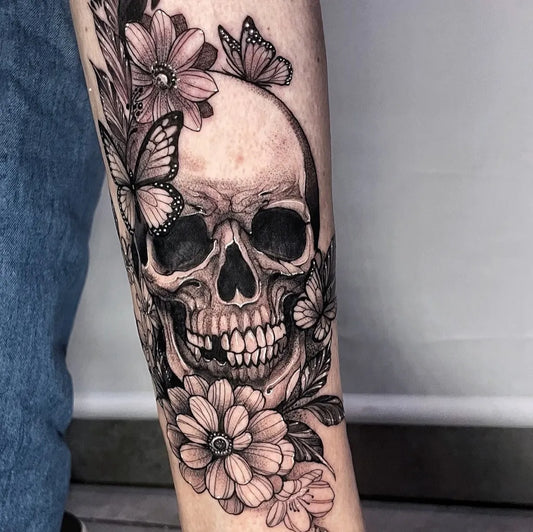 Big Blackwork Skull Flowers Butterflies on Women Arm Tattoo by @eleonora_tattooartist