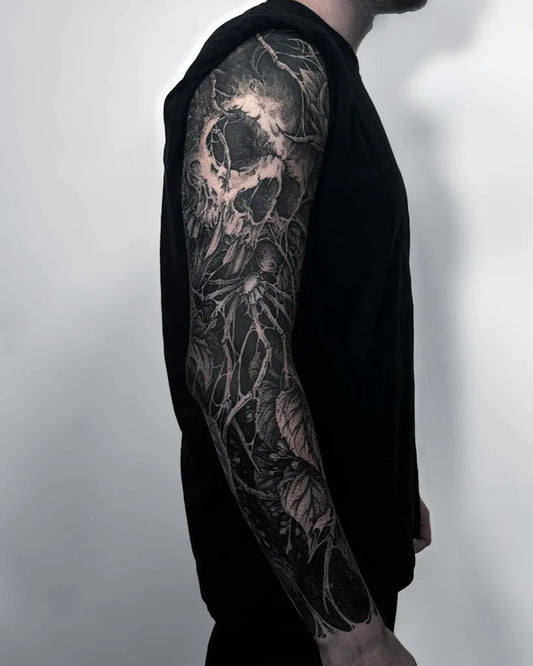 Big Blackwork Skull Flowers Roots on Men Arm Tattoo by @szczuply.ink