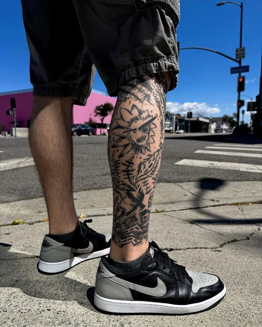 Big Blackwork Skull and Flowers on Men Leg Tattoo by @denizcimlikaya