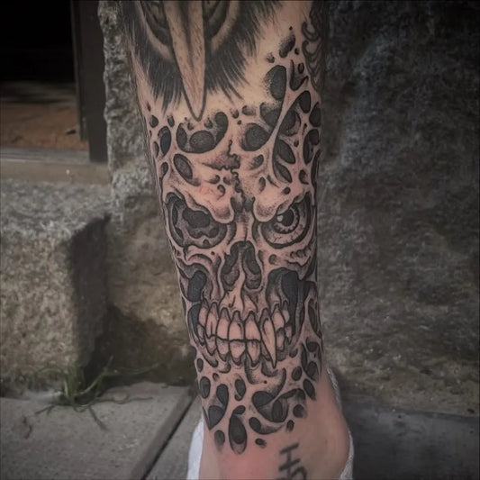 Big Blackwork Skull and Raven on Men Leg Tattoo by @sthlmclassictattoo