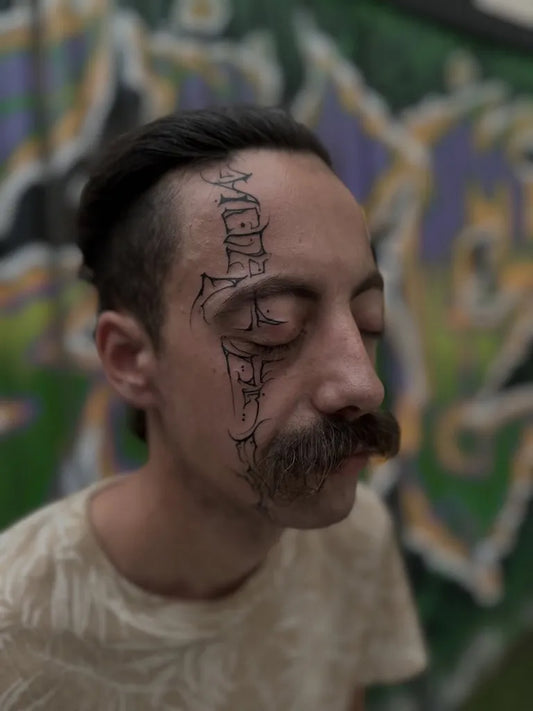 Big Blackwork Skull and Script on Men Face Tattoo by @nomad_inked