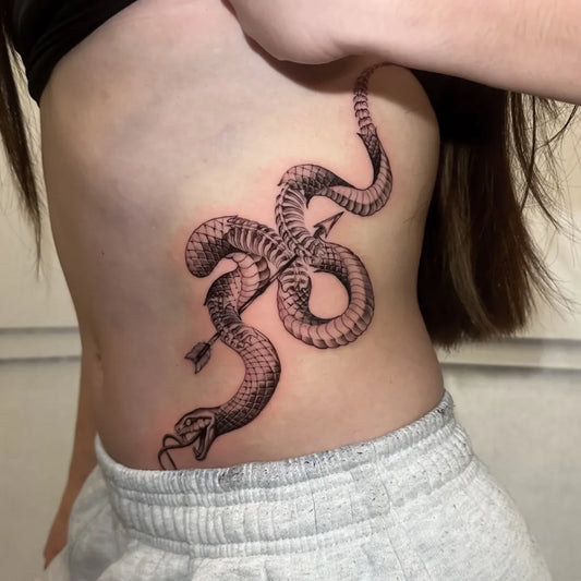 Big Blackwork Snake and Arrow on Women Rib Tattoo by @tattooheaven_official