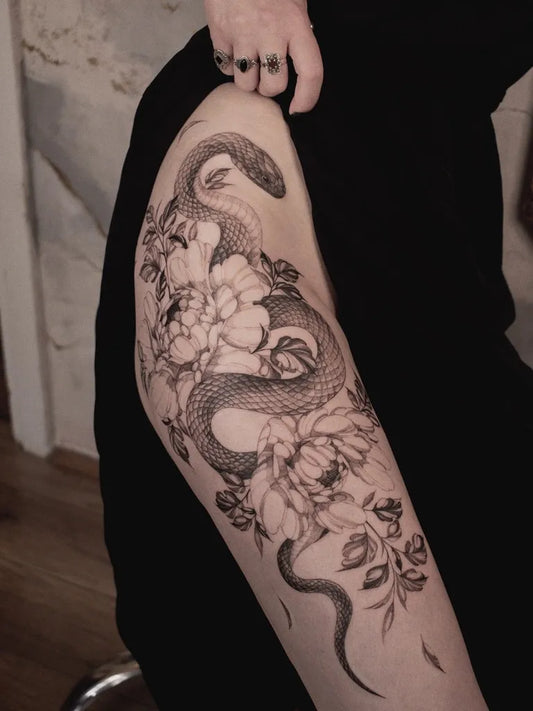 Big Blackwork Snake and Flowers on Women Thigh Tattoo by @princelet_tattoo