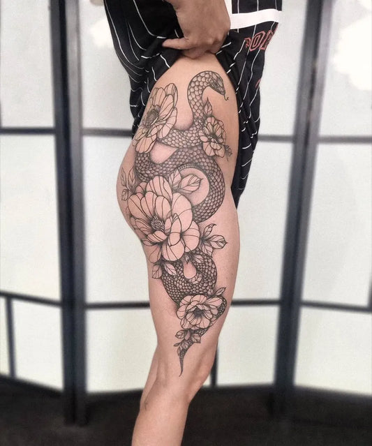 Big Blackwork Snake and Peonies on Women Thigh Tattoo by @phantominktattooshop