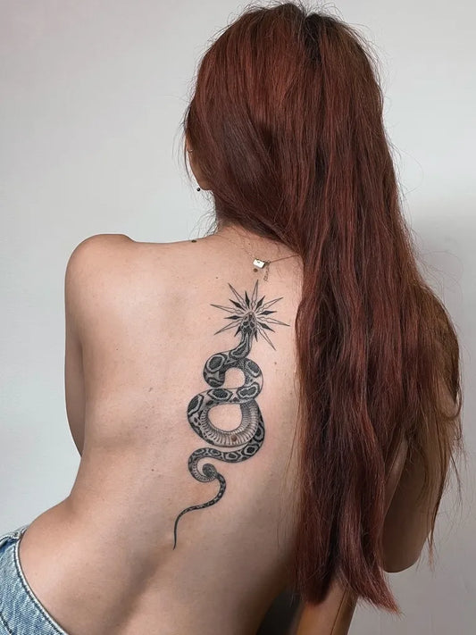 Big Blackwork Snake and Star on Women Back Tattoo by @mais.hmaidan