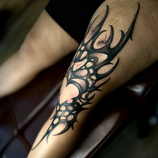 Big Blackwork Spiky Tribal Wings Tattoo on Women Knee by @lkt_luciano