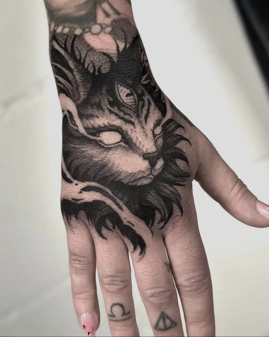 Big Blackwork Supernatural Cat on Women Hand Tattoo by @basti.dee.tattoo