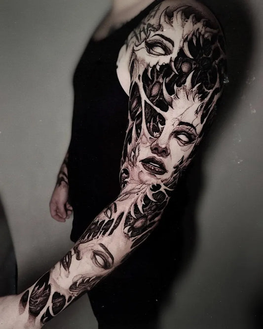 Big Blackwork SurrealFaces on Women Arm Tattoo by @orfen_krakow