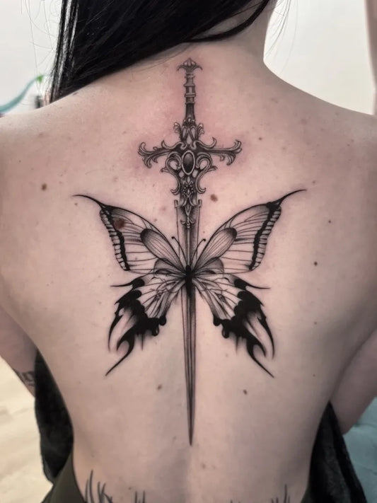 Big Blackwork Sword and Butterfly on Women Back Tattoo by @couchpotatoinkz