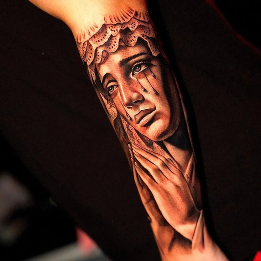 Big Blackwork Virgin Mary with tears and praying hands on Women Arm Religious Tattoo by @ezequiel_vidal_tattoo