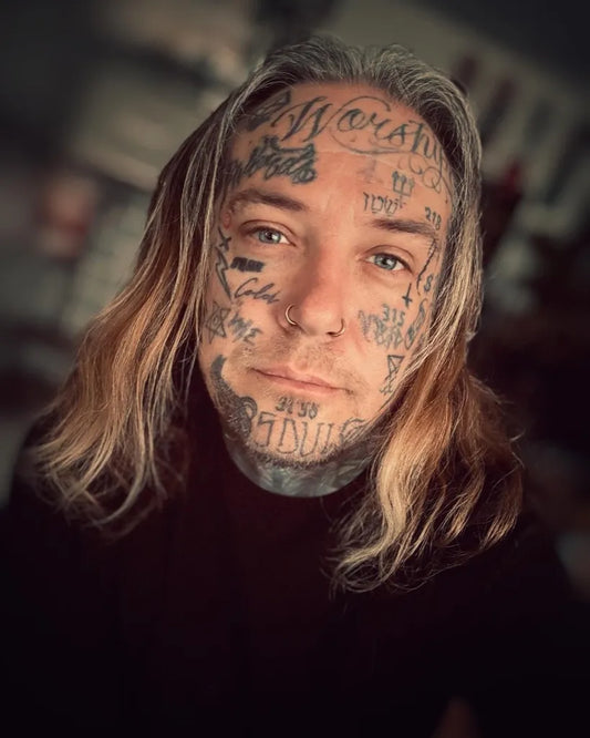 Big Blackwork Words and Symbols on Men Face Tattoo by @bjorn_aka_flekjack