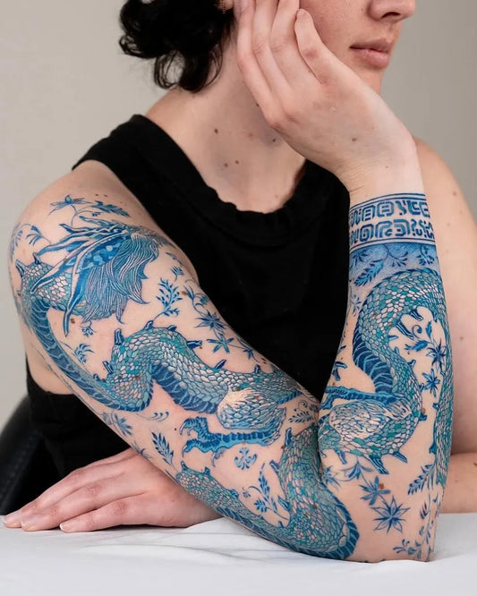 Big Blue Dragon Flowers Tattoo on Women Arm by @theartoftattooingofficial