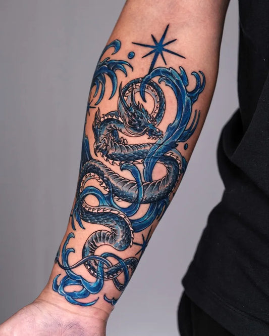 Big Blue Dragon Waves Tattoo on Men Arm by @melange.tattoo
