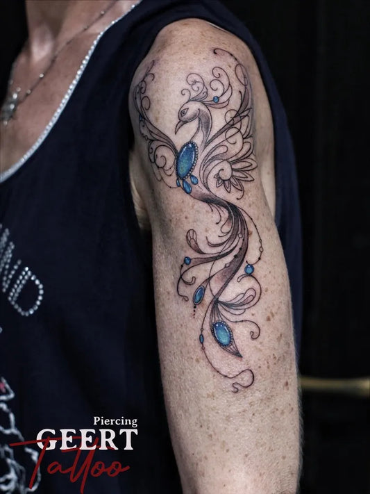Big Blue Phoenix Tattoo on Women Arm by @geert_tattoo_piercing