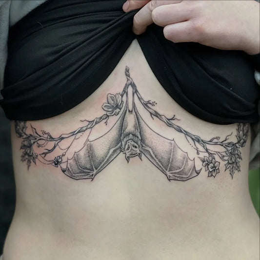 Big Botanical Bats and Flowers on Women Sternum Tattoo by @maemae_tattoos