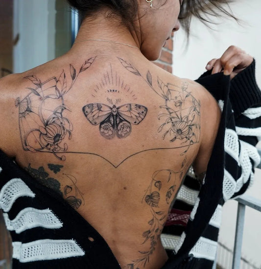 Big Botanical Butterfly Flowers on Women Back Tattoo by @inkluded.tattoo