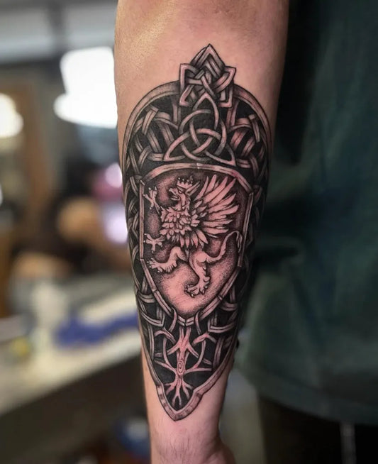 Big Celtic Shield with Dragon and Knotwork Tattoo on Men Arm by @four_scythes_tattoo