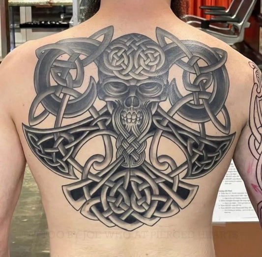 Big Celtic Skull and Axes Tattoo on Men Back by @piercedhearts