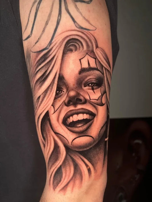 Big Chicano Smiling Woman with Diamonds Tattoo on Women Arm by @officinatattoomilano