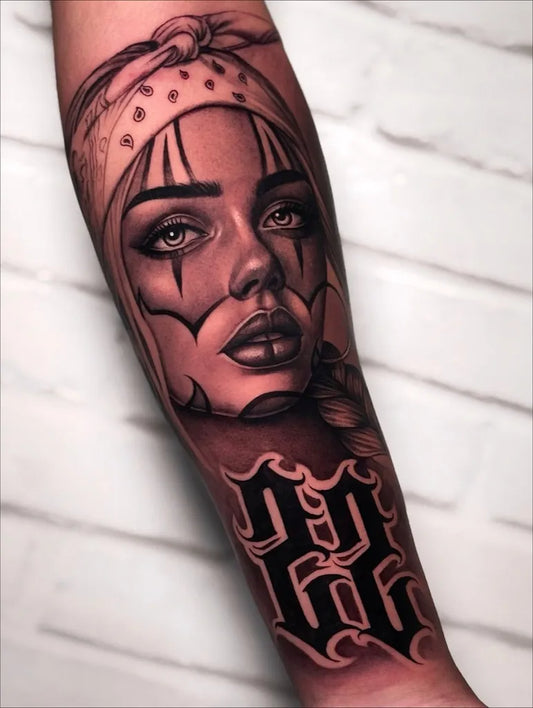 Big Chicano Woman with Clown Makeup and 13 Letters Tattoo on Women Arm by @pedroferrertattoo