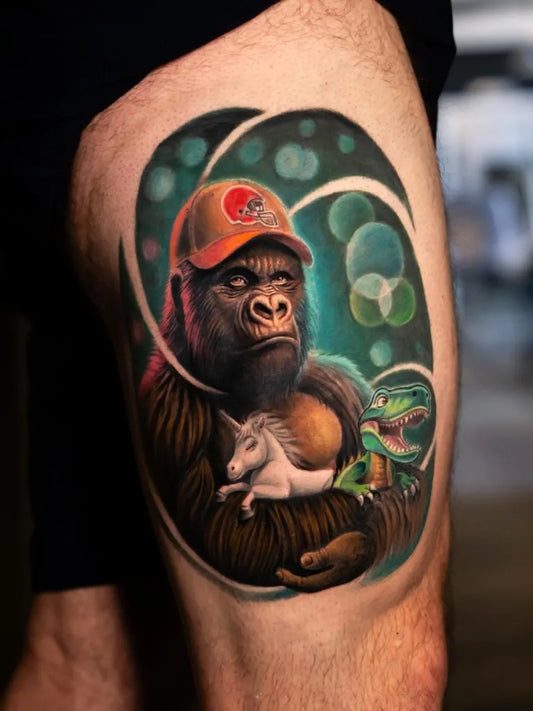 Big Color Realism Gorilla with Unicorn and Dinosaur Tattoo on Men Thigh by @tattoos.bynico