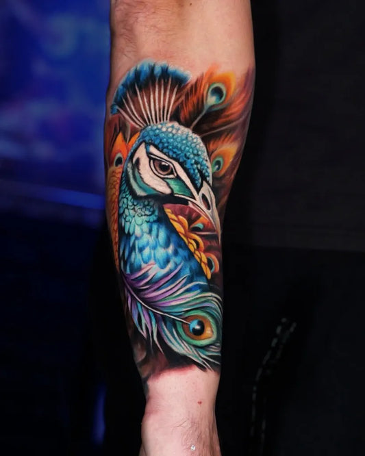 Big Color Realism Peacock Tattoo on Men Arm by @rajczak.ink