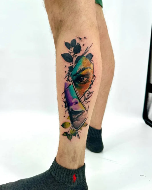 Big Colorful Face With Leaves Tattoo on Men Leg by @bhsoceana