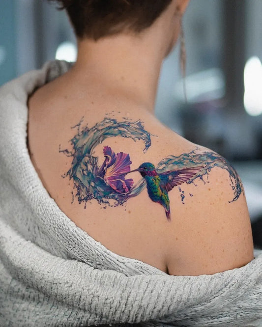 Big Colorful Hummingbird Water Splashes Tattoo on Women Shoulder by @debrar