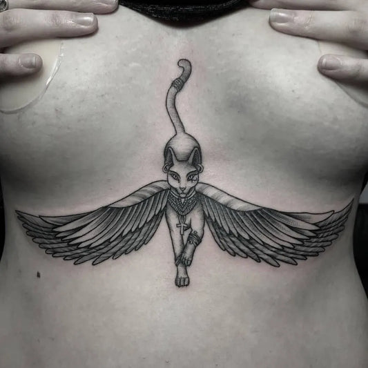 Big Egyptian Winged Cat on Women Sternum Tattoo by @inkammostudios