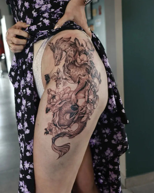 Big Fantasy Dragon with Flowers on Women Thigh Tattoo by @dot_line_tattoo