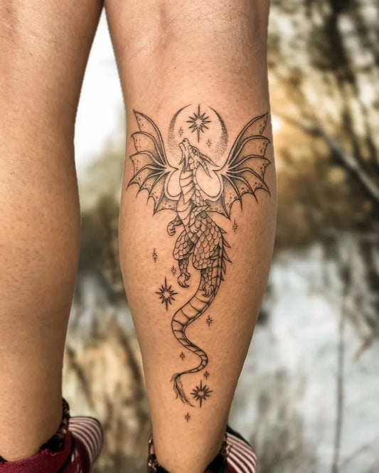 Big Fantasy Dragon with Moon and Stars on Women Thigh Tattoo by @uprooted_ink