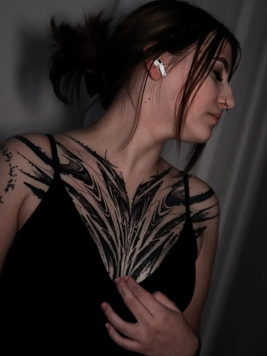 Big Feather and Wave on Women Chest Tattoo by @dexael.art