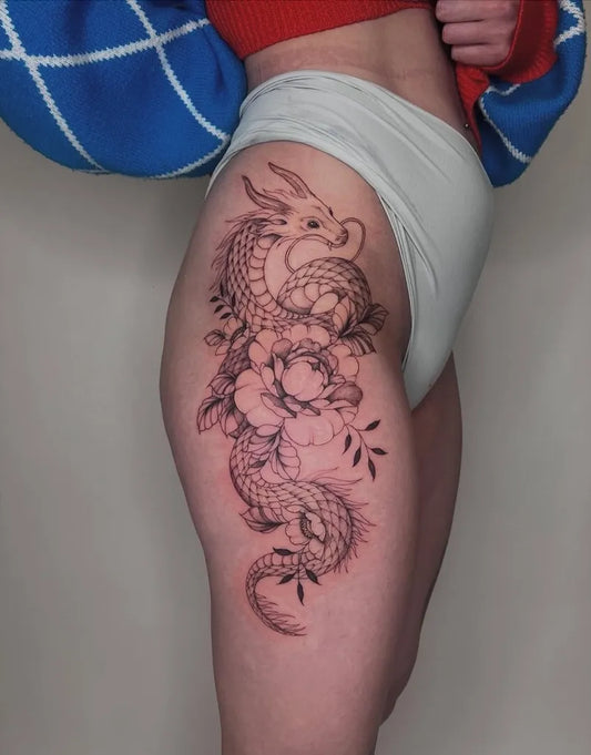 Big Fine Line Dragon and Peonies on Women Thigh Tattoo by @thearcadetattoos