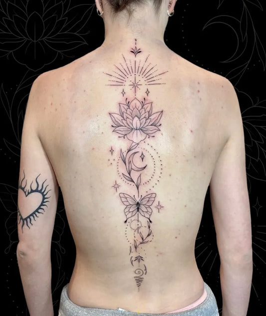 Big Fine Line Lotus Butterfly Sun on Women Spine Tattoo by @grizzlyayretattoos
