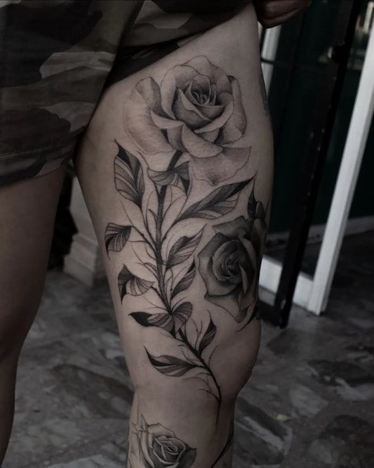 Big Fine Line Rose Vine on Women Thigh Tattoo by @carbonero.tattoo
