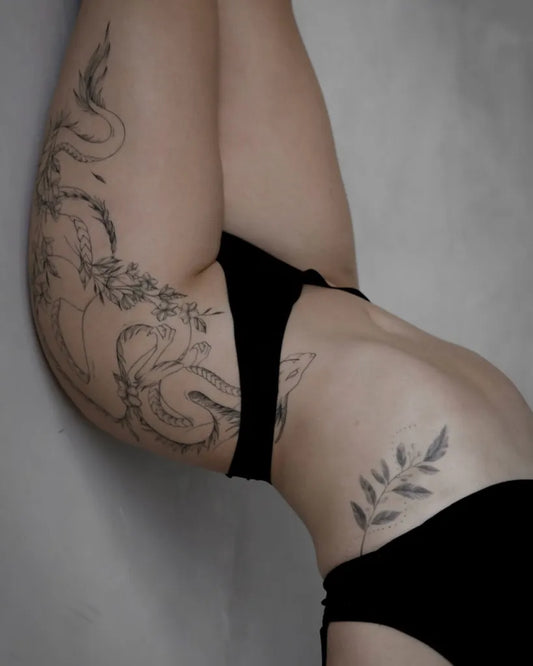 Big Fine Line Snake and Flowers Tattoo on Women Hip by @loftn5tattoo_bali
