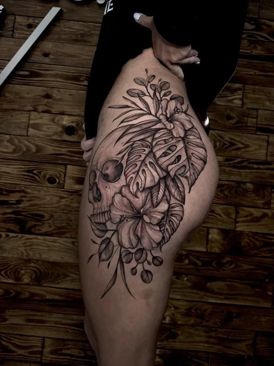 Big FineLine Skull and Monstera Leaves on Women Thigh Tattoo by @alinatatts