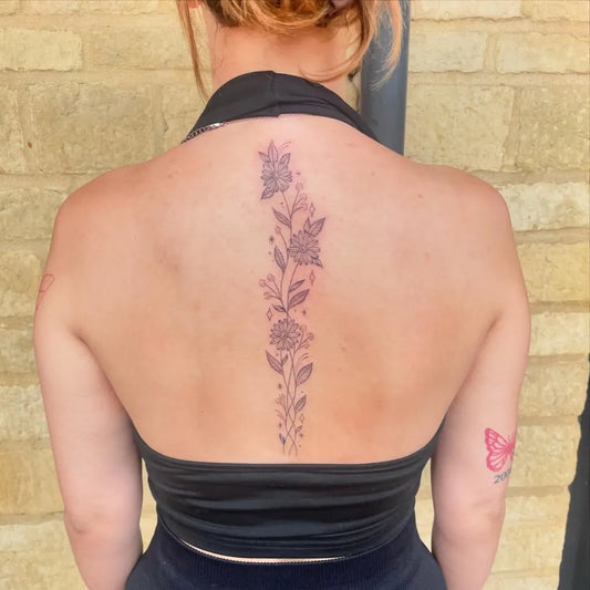 Big Floral Flowers and Leaves on Women Spine Tattoo by @sophiekennedy.tattoos