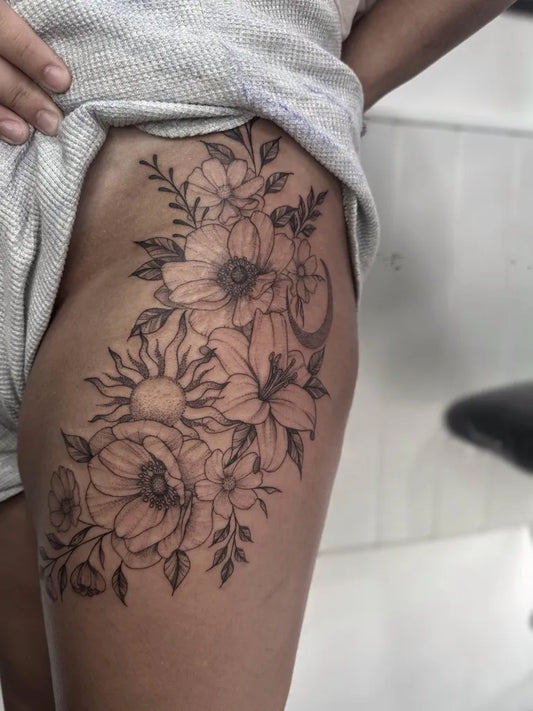 Big Floral Flowers and Moon on Women Thigh Tattoo by @eternalcanvastattoocollective