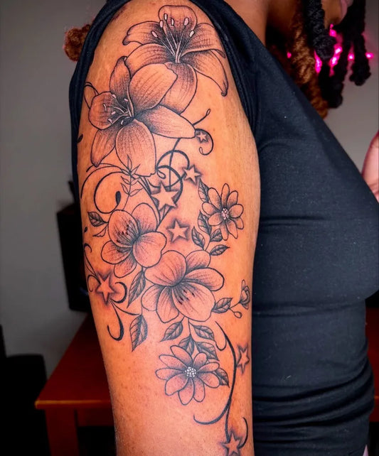 Big Floral Lilies and Stars on Women Arm Tattoo by @jbird.ink