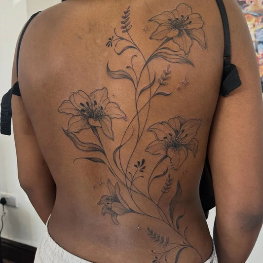 Big Floral Lily Flowers on Women Back Tattoo by @manvmadetattoos