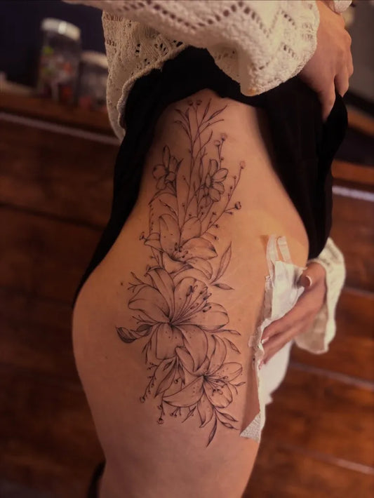 Big Floral Lily Flowers on Women Thigh Tattoo by @laurahandstattoo