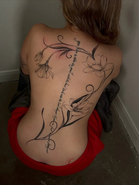 Big Floral Script Flowers and Vines on Women Back Tattoo by @daniatats