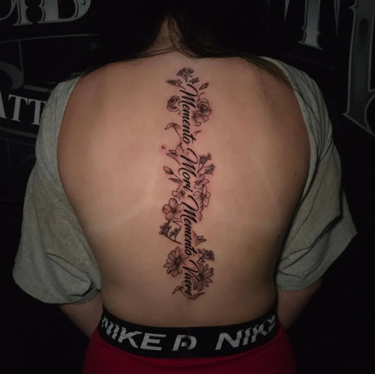 Big Floral Script Words and Flowers on Women Spine Tattoo by @inkedbylalo