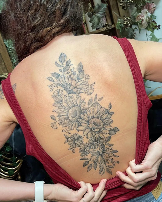 Big Floral Sunflowers on Women Spine Tattoo by @breestingertattoo
