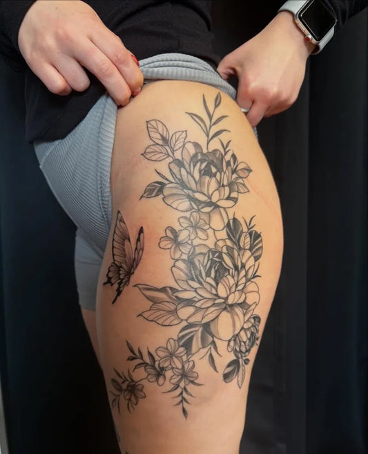 Big Floral and Butterfly on Women Thigh Tattoo by @d_goddess_tattoos