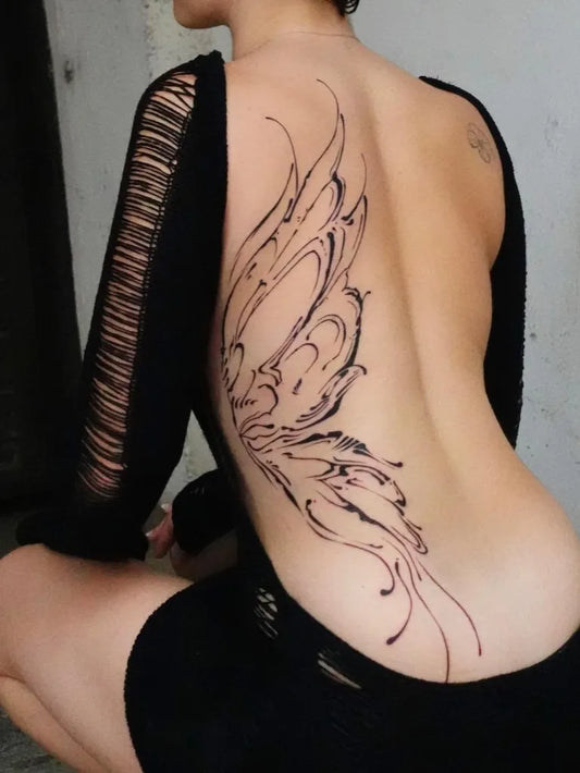 Big Flowy Wings on Women Back Tattoo by @dinami.nk