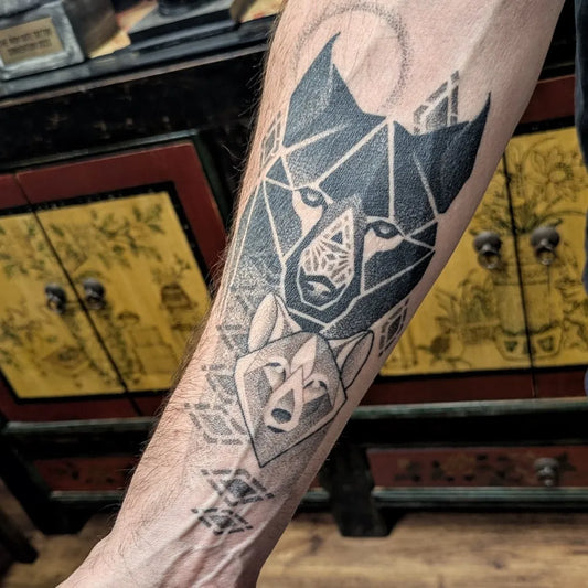 Big Geometric Wolf Pack on Men Arm Tattoo by @bendoukakistattoo