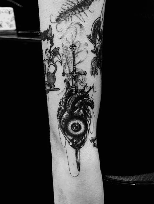 Big Gothic Heart Sword Eye Tattoo on Women Arm by @seb_tatts