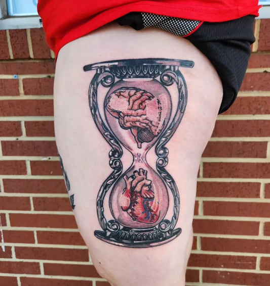 Big Illustrative Hourglass with Brain and Heart Tattoo on Women Thigh by @wicked_catz_tattoo